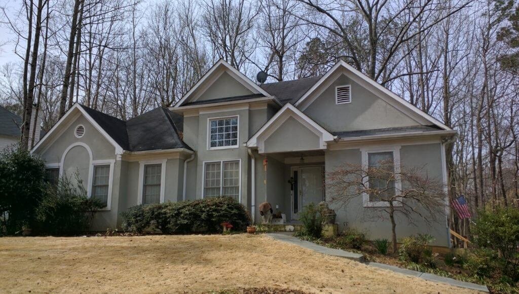 home with old green & white stucco
