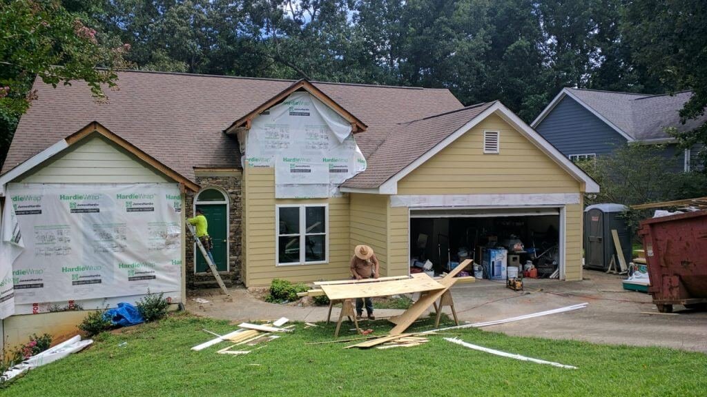 home getting new hardie plank siding in yellow